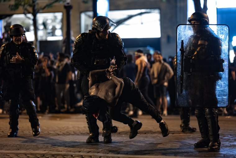 Celebrations And Clashes Following PSG's Victory On The Champs-Élysées