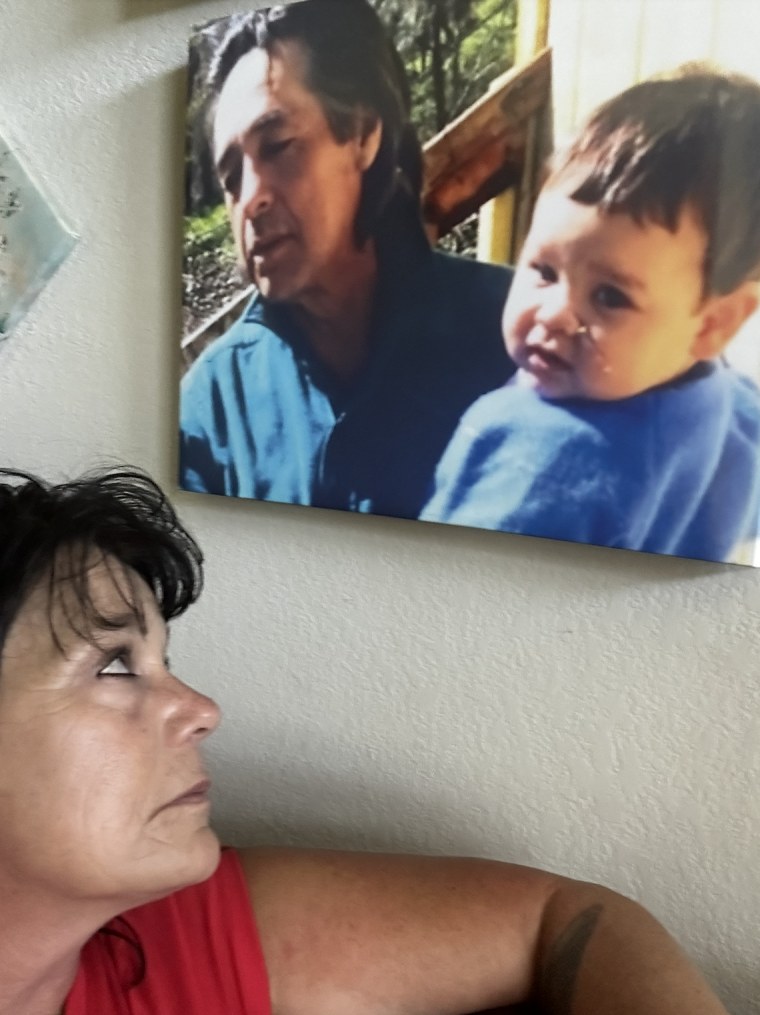 Heather Allen with a photo of Roy and his father 