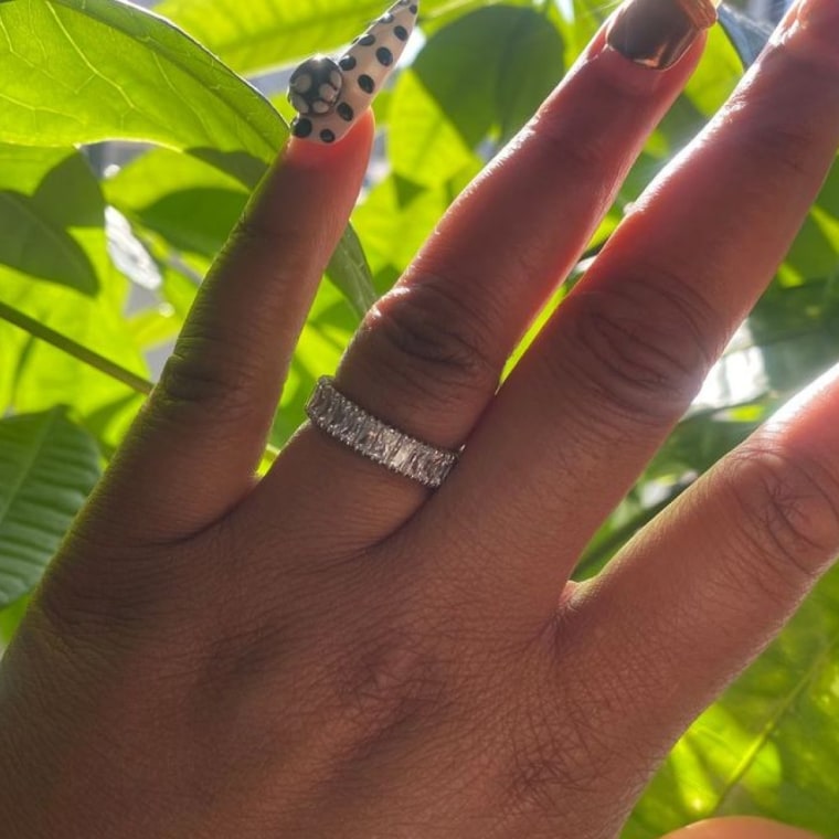 Photo of woman’s hand wearing crystal ring