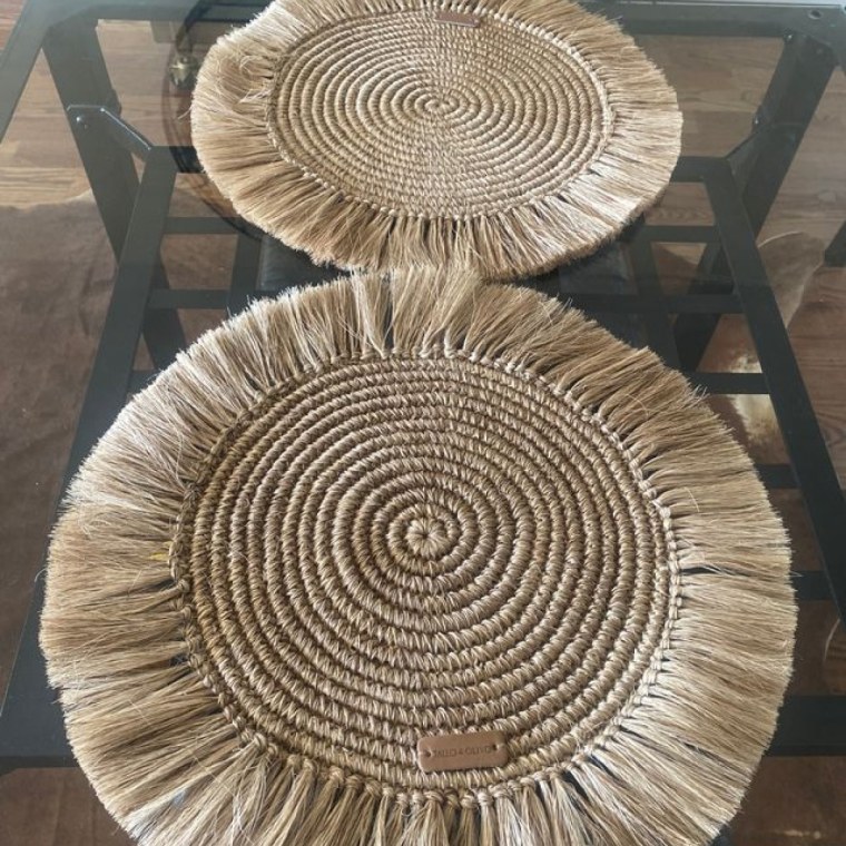 A fringe placemat on a dining room table