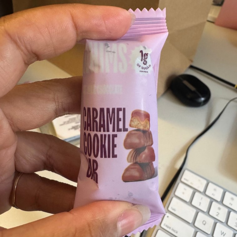 Person holding Whims Oat Milk Chocolate Caramel Cookie Bar.