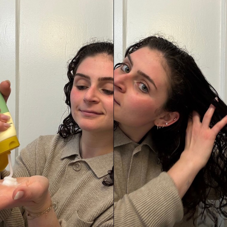 Woman squeezing the Narka Hair Milk out of the bottle and applying it to the right side of her hair.