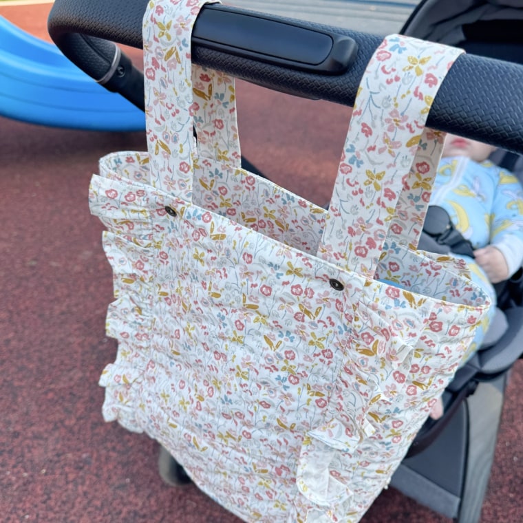 This stylish diaper bag stays secured to the handles of all kinds of strollers.