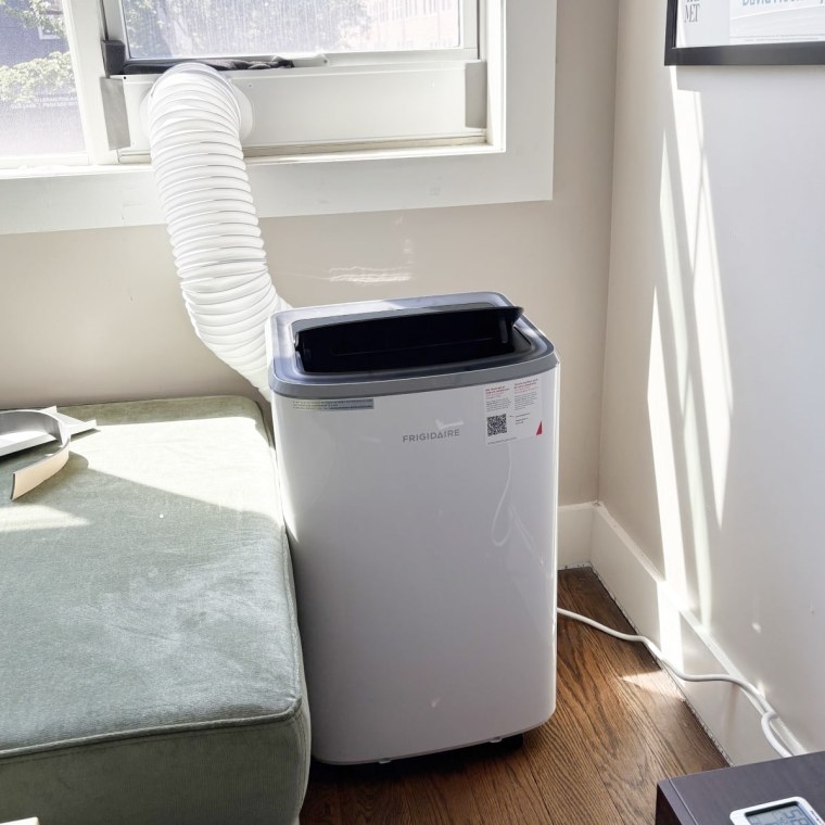 The Frigidaire portable AC is a bit larger than some units, but still fits snugly in this corner. 