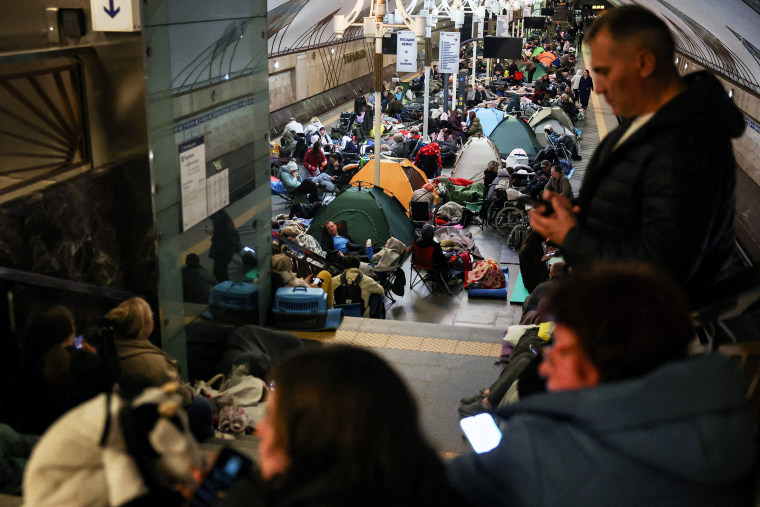 People take shelter inside a metro station during a Russian air strike in Kyiv