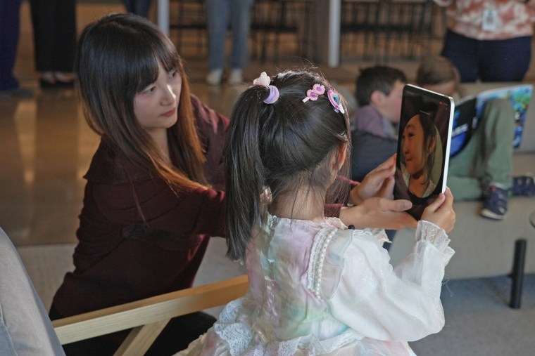 Parents and children tested out Roblox's new biometric age-checking tool at the company's San Mateo, Calif., headquarters in May 2026.