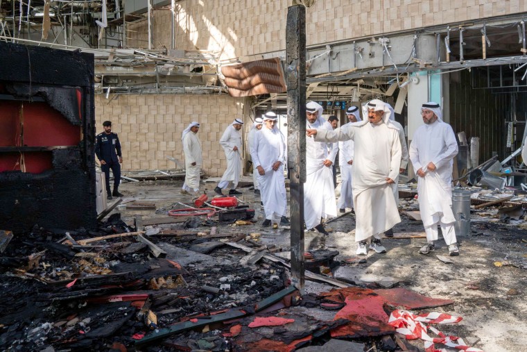 Kuwaiti officials inspect damage inside a terminal at Kuwait International Airport following a drone and missile attack, in Kuwait City