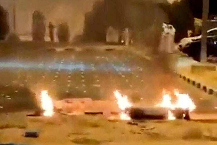 Debris burns in Kuwait following reports that air defences intercepted missile and drone attacks