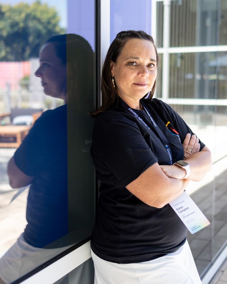 Karen Compton leans against a glass wall