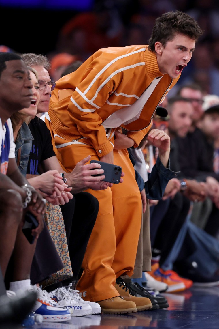 Timothee Chalamet cheers courtside.