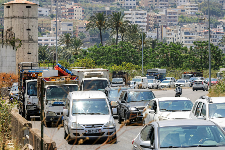 Cars drive on a road outside