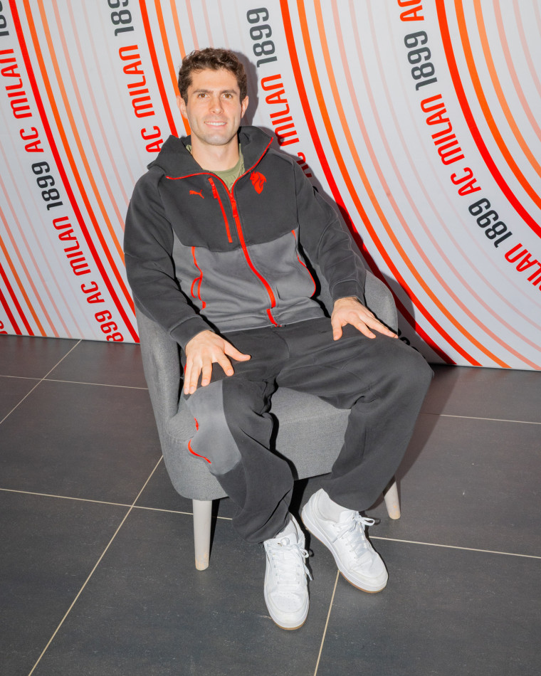 Christian Pulisic poses for a portrait while seated in a chair