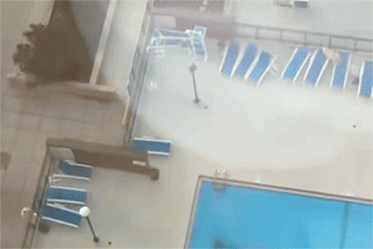 chairs flying into oncoming traffic during windy day in Chicago