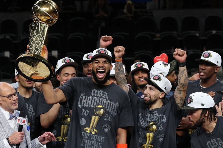 Karl-Anthony Towns of the New York Knicks lifts the Larry O'Brien Championship Trophy