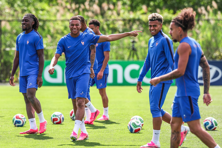 Team France players practice on the soccer field, Mbappe is center