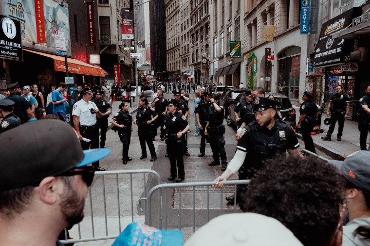 Police adjust barricades at a security checkpoint at Nassau Street and Maiden Lane.