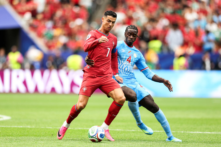 Cristiano Ronaldo of Portugal is challenged by Axel Tuanzebe on the soccer field