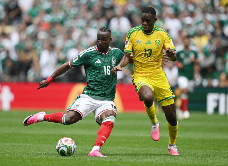 Julian Quinones of Mexico runs next to Mbekezeli Mbokazi on the soccer field