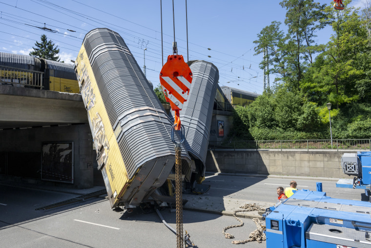 After two freight train cars fell off a bridge