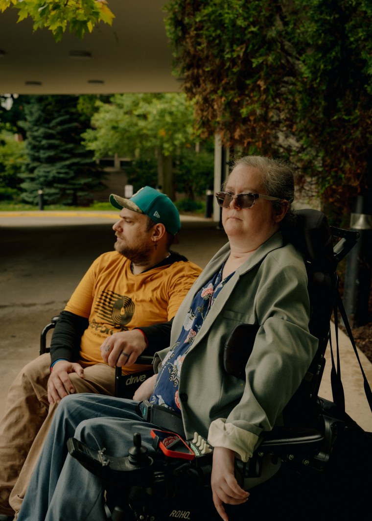 Greg Anger, left, and Rebecca Anger sit outside in their wheelchairs