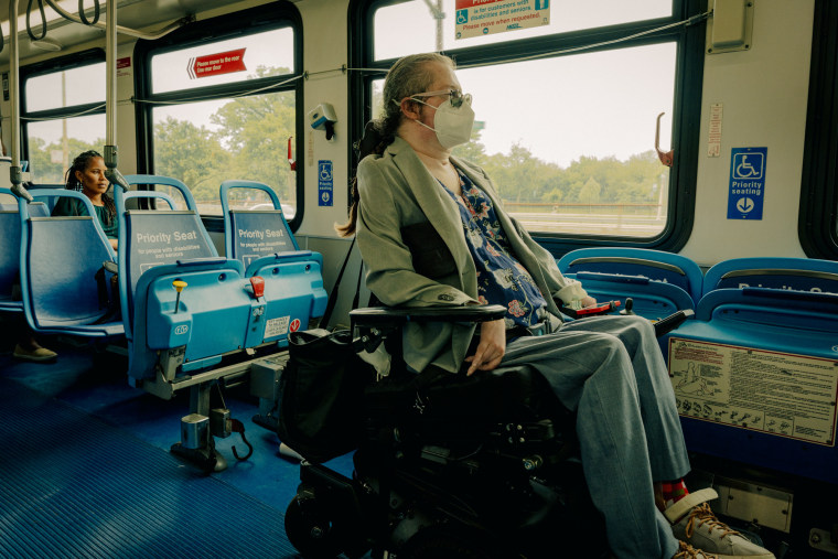 Rebecca Anger is seen riding the bus in the priority section while seated in a wheelchair