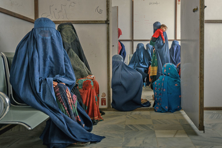 Habiba, 40, holds her one-year-old niece Maissa, as she waits at an underfunded district hospital in Ghazni, Afghanistan, in 2025.