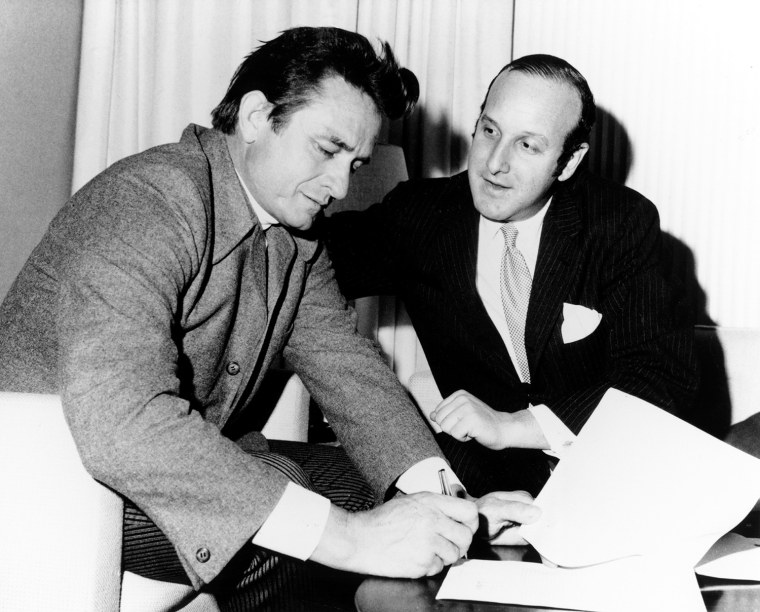 Johnny Cash signs a record contract with Clive Davis in 1960.Colin Escott / Getty Images file