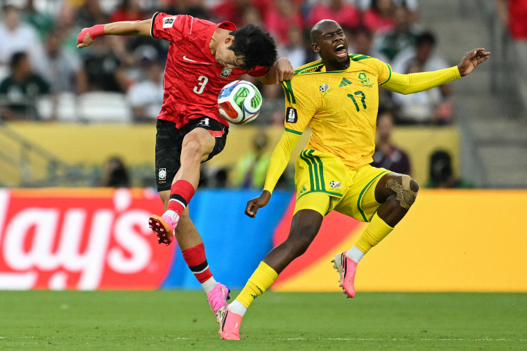 South Korea's defender #03 Lee Gi-hyuk and South Africa's forward #17 Evidence Makgopa fight for the ball during South Africa and South Korea game.