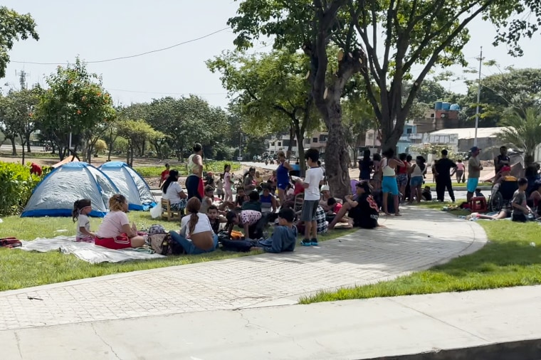 People camp in an open space in La Guaira, Venezuela.