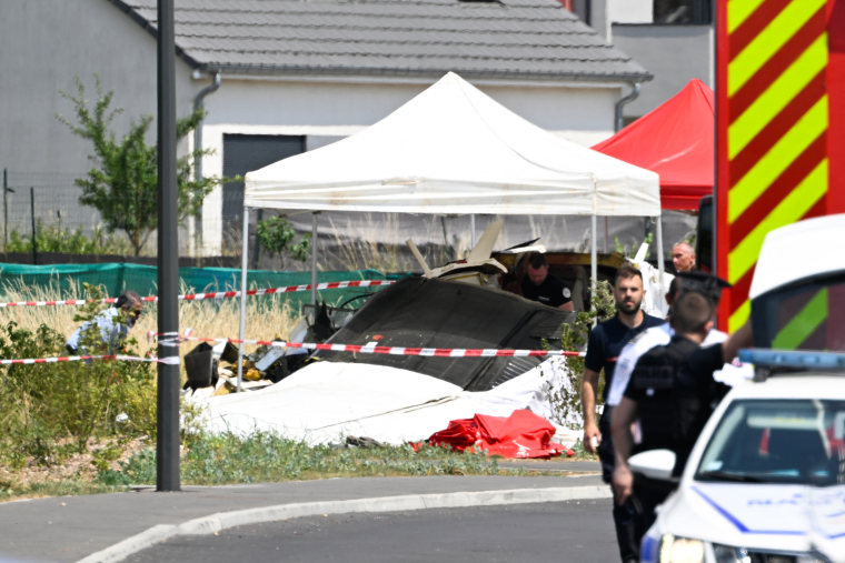 Security personnel look at the wreckage of a Pilatus PC-6 light aircraft after it crashed at Tomblaine, on the outskirts of Nancy, eastern France on June 28, 2026.