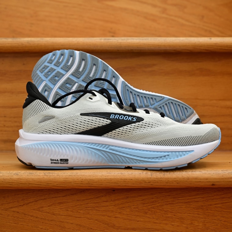 A close-up of the Brooks Ghost 18 resting against a wooden stair.