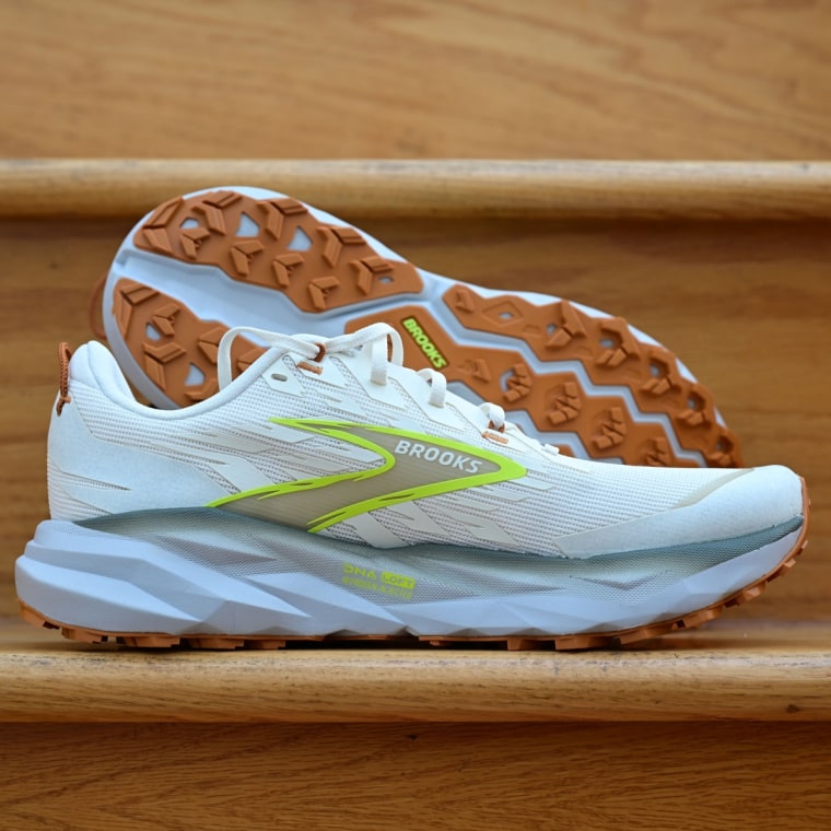 A close-up of the Brooks Cascadia 19 resting against a wooden stair.