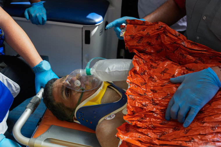 Rescue workers attend to Hernán Alberto Gil Flores after he was pulled from the rubble in Venezuela Earthquake.