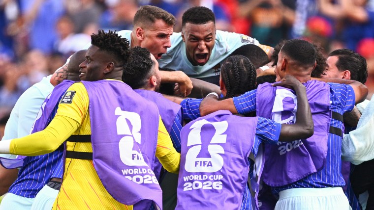 Kylian Mbappé (France, top) and his teammates celebrate scoring a second goal.