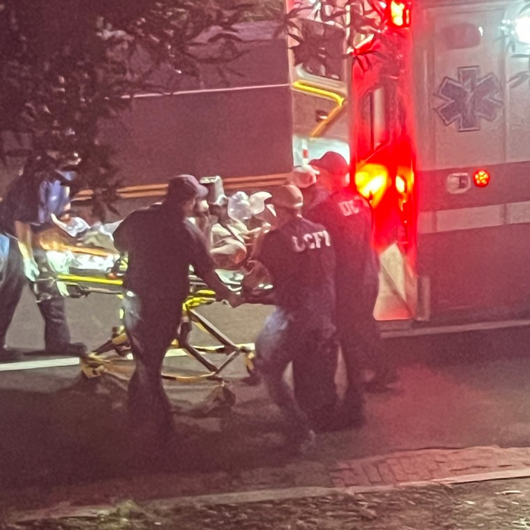 Lindsey Graham is wheeled from his home into an ambulance outside, EMTs surround him