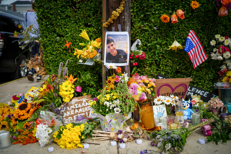 A makeshift memorial for Johan Sebastián Durán Guerrero with flowers, flags, signs and photos.