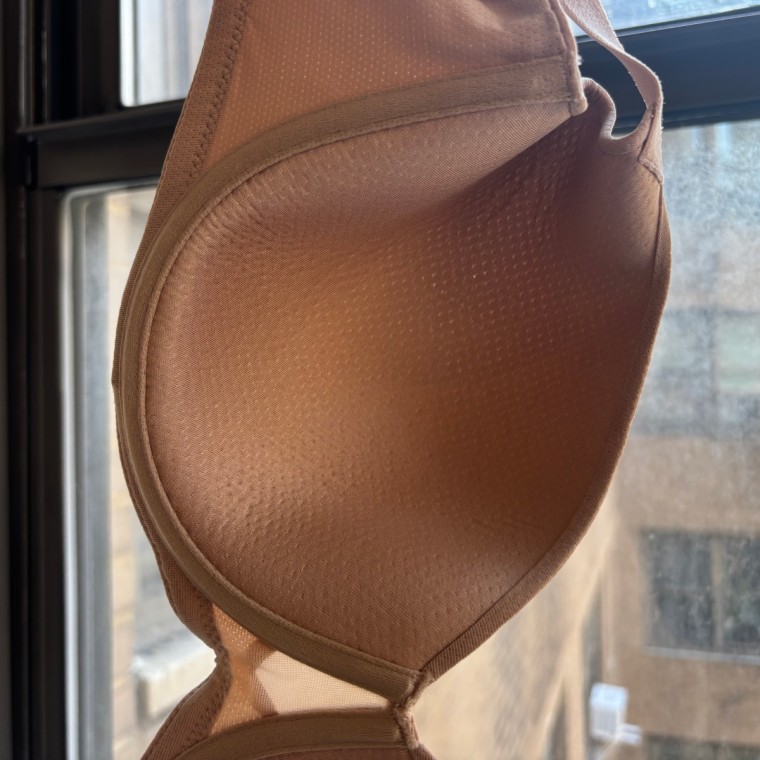A close-up image of the inside of a cup on the Thirdlove TempSync T-Shirt Bra, showing the tiny perforations in the nude-colored material.