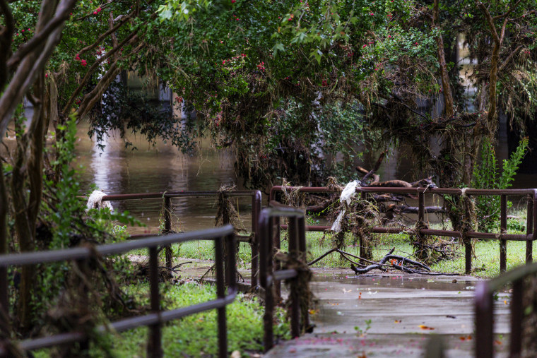 Flood debris wraps around railings.