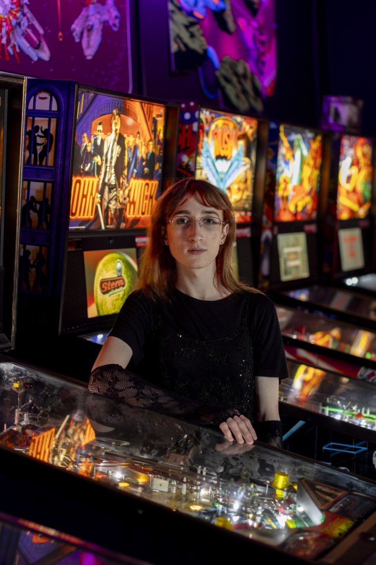 Emi Erwin near pinball machines.
