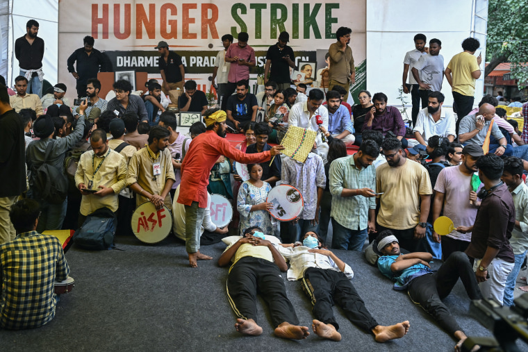 Cockroach Janta Party (CJP) supporters rest during a sit-in protest demanding the resignation of India's Education Minister Dharmendra Pradhan over alleged NEET examination irregularities in New Delhi on July 18.