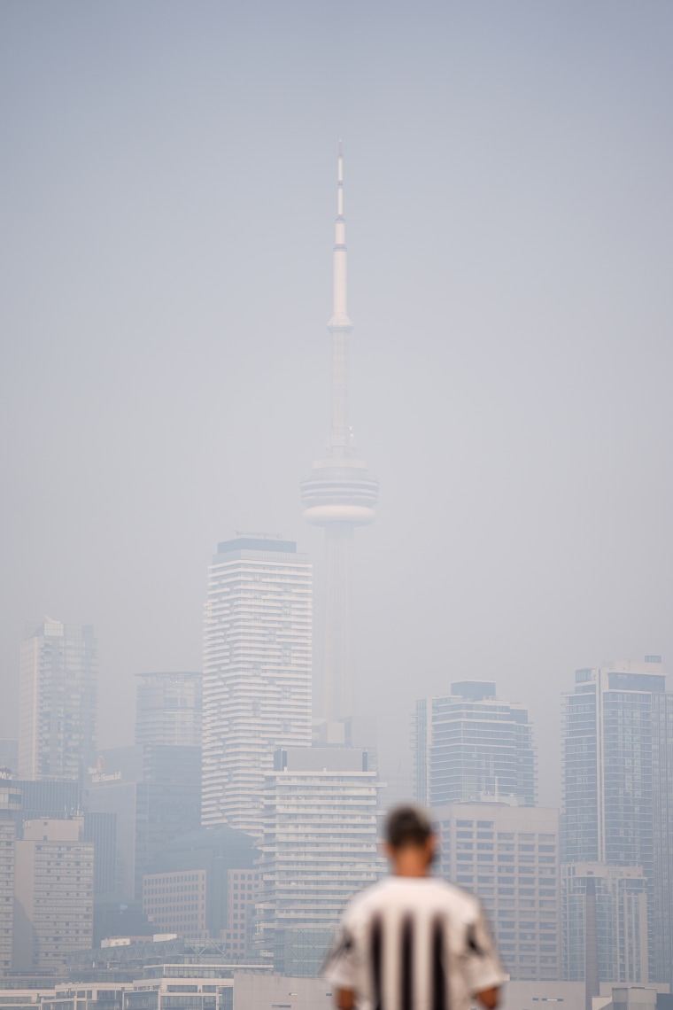 High-rise buildings in Toronto are partially obscured by thick smoke in the air.