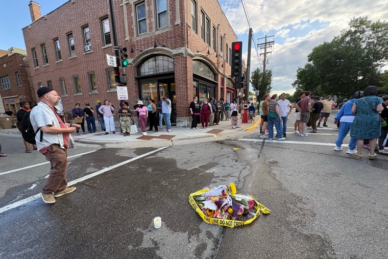 People gather at the scene of the police shooting on Madison's Williamson Street on Wednesday, July 22, 2026.