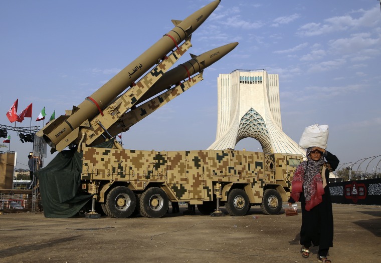 Two large missiles mounted on a long camouflage truck in Tehran.