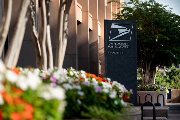 Signage is displayed outside U.S. Postal Service headquarters.