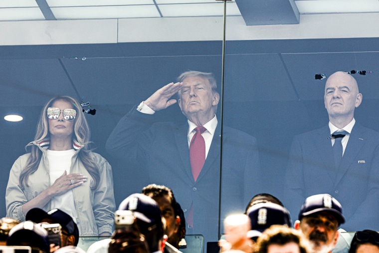 Melania Trump and Donald Trump, saluting during the national anthem, and Gianni Infantino behind glass in a private suite.