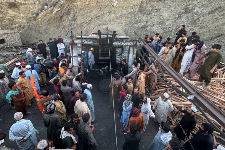 People gather outside a coal mine in Pakistan.