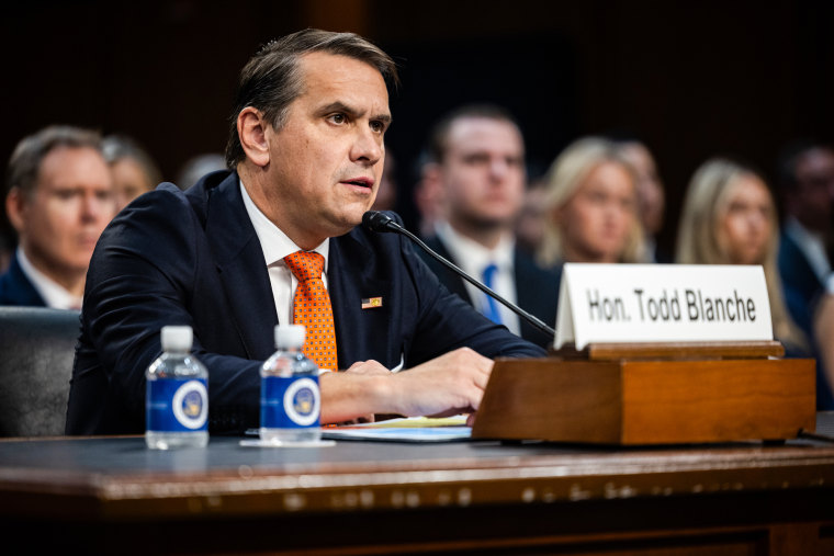 Todd Blanche speaks while seated in a hearing room