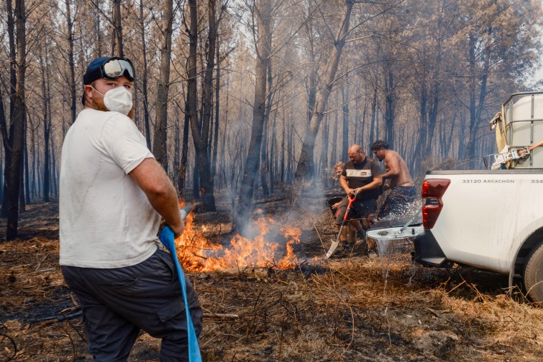 People fight wildfire.