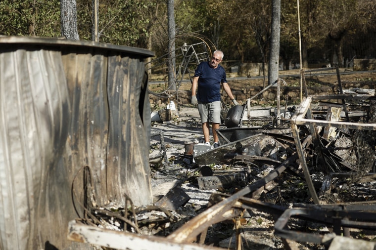 A man searches through the rubble 
