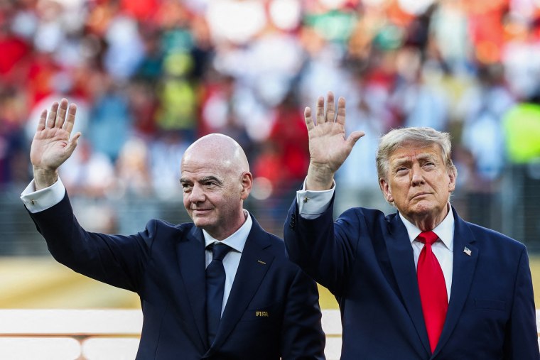 U.S. President Donald Trump (R) and FIFA President Gianni Infantino (L) wave during the World Cup at the New York/New Jersey Stadium.